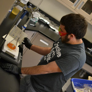 former LCU student Bryan Hettick performing chemistry experiment