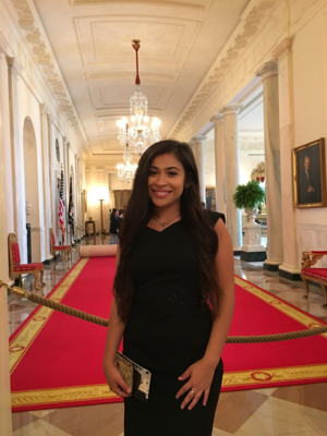 Rita posing in a hallway at The White House