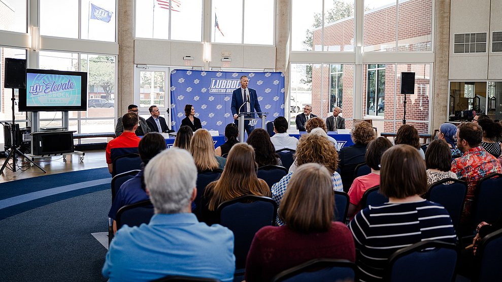 Inside the Rotunda of the Cardwell Welcome center. President Scott McDowell is delivering a speech to several people in seated in the audience.