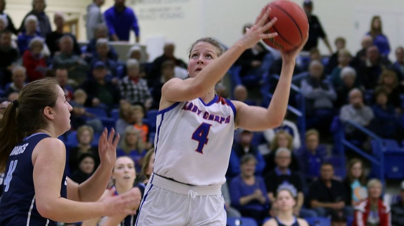 Lady Chap basketball player shoots basketball with rival team defending