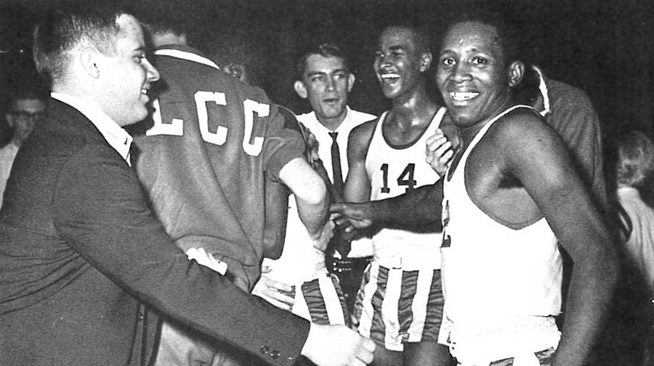 Bubba Harris looking at camera after a basketball game, surrounded by other players