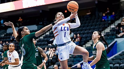 Photograph of LCU baseball player going up for a layup