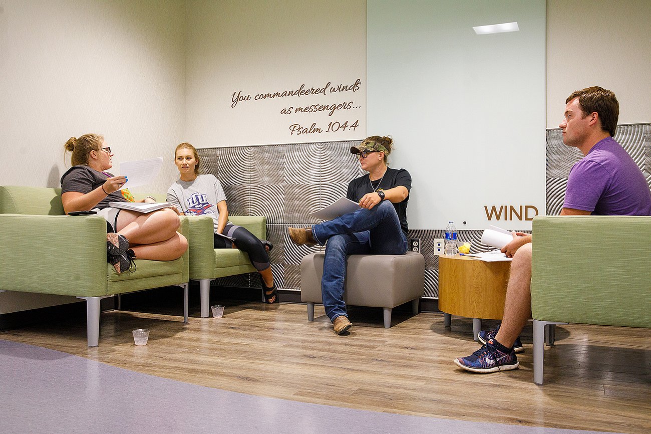 students sitting and talking in the wind corner in the ling science center