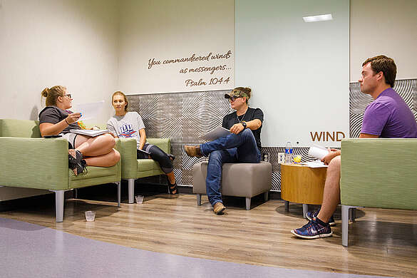 students sitting and talking in the wind corner in the ling science center