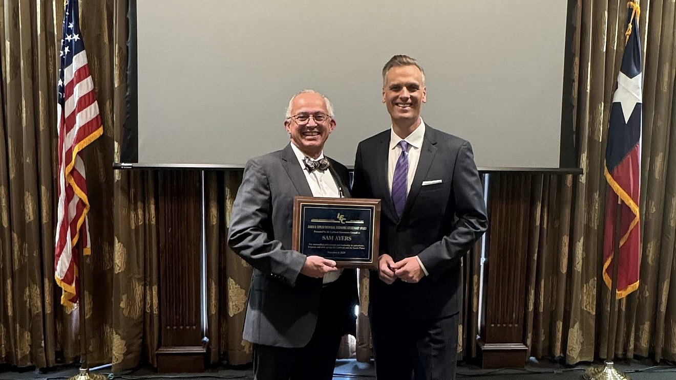 Photograph of Dr. Ayers receiving award, shaking hands with the presenter