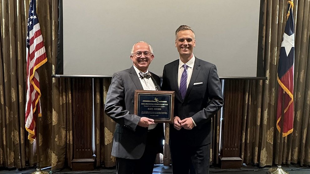 Photograph of Dr. Ayers receiving award, shaking hands with the presenter