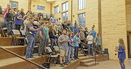 students singing praise songs inside