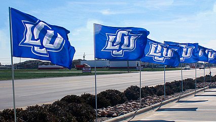 LCU flags in front of Lubbock community partner business