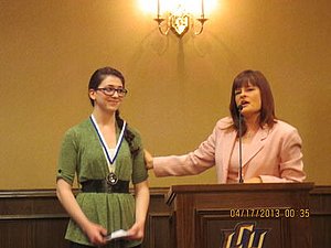 Caitlin receiving an award