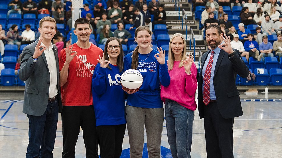 Grace Foster presented with game ball by LCU Lady Chap legend Nicole Hampton, whose all-time scoring record she broke