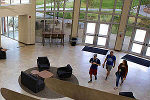 Shot from second story overlooking students walking through the lobby