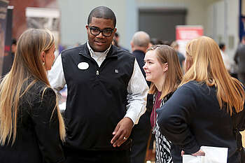 students and recruiter talking at career fair