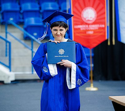 A student graduates with her diploma