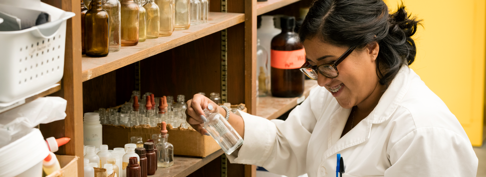 LCU student looking through glassware in a storage closet