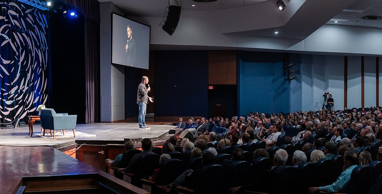 photo of Dallas Jenkins on stage for the presentation