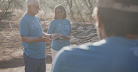 Two teacher leading a group at sunset