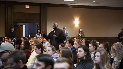 TJ Ojehomon speaking in room of students