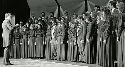 Historical photo of Dr. Wayne Hinds directing chorus