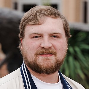 Headshot photograph of Ben