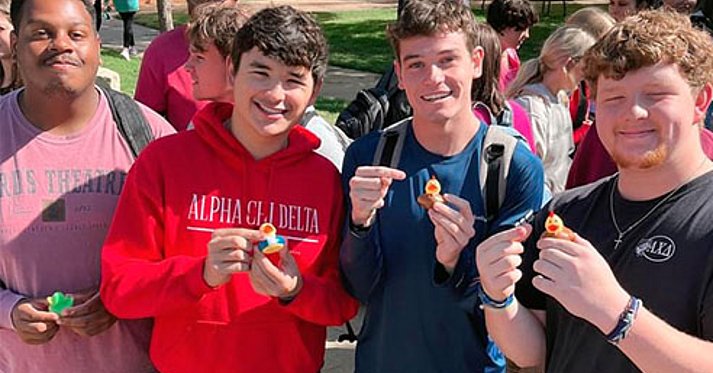 LCU students holding a yellow duck for ducky day