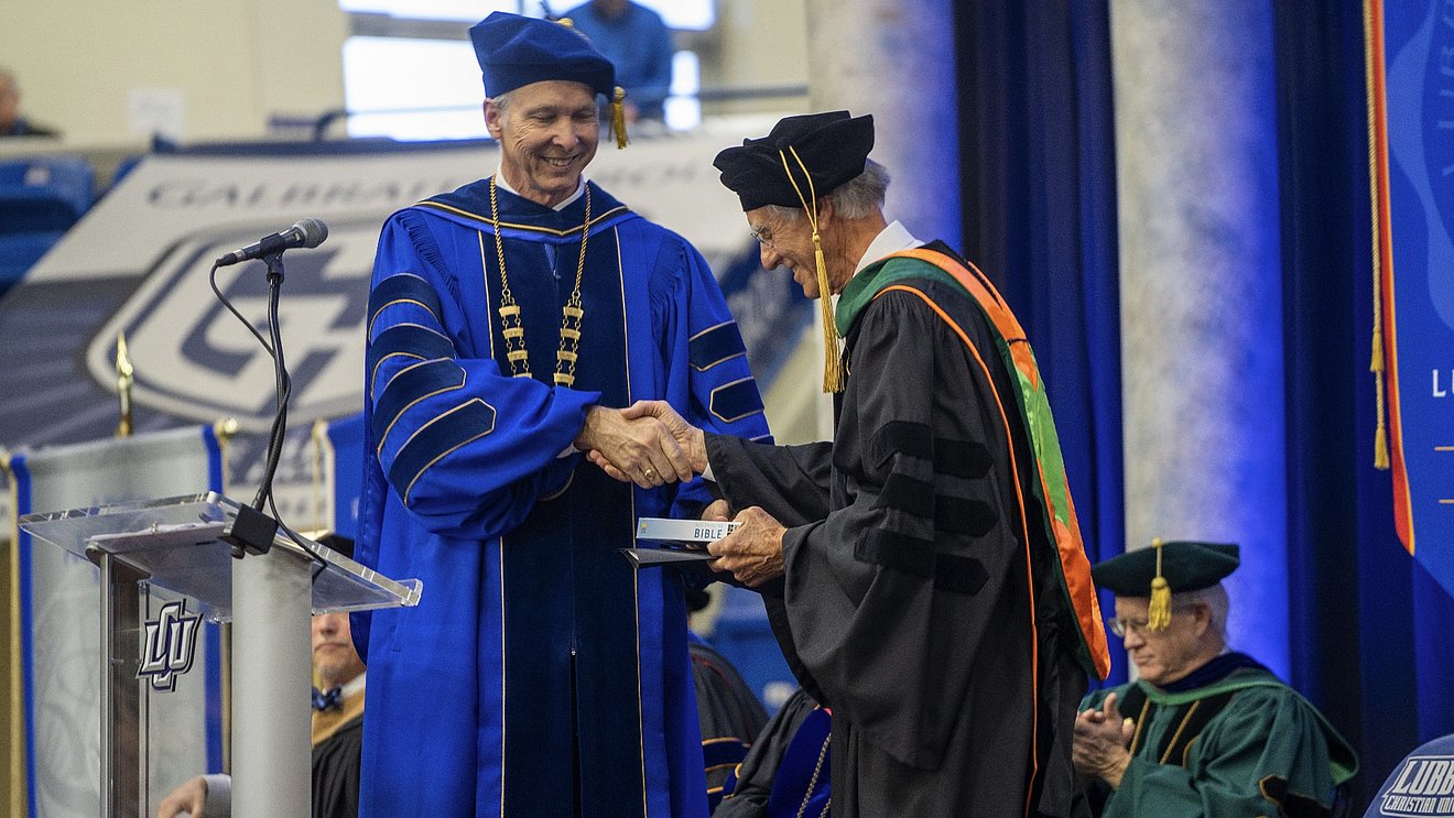 President McDowell shakes B. Ward Lane's hand at the undergraduate commencement ceremony