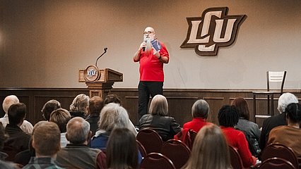 Photograph of Marty Solomon speaking at LCU in the Baker Conference Center from 2023