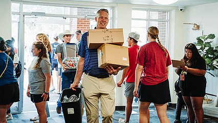 President Dr. Scott McDowell helping move freshmen into the LCU residence halls