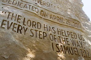 Ebenezer stone with scripture etched into the front