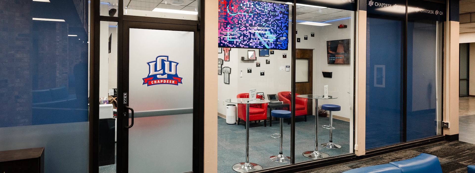 Photo of a glass door into a technology office labeled "Chapdesk"