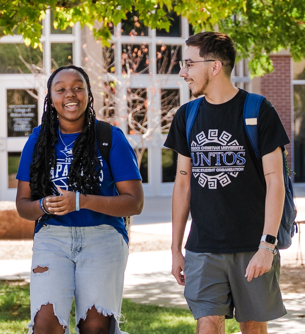 Photograph of Rebecca Kimani walking outside at LCU with another student