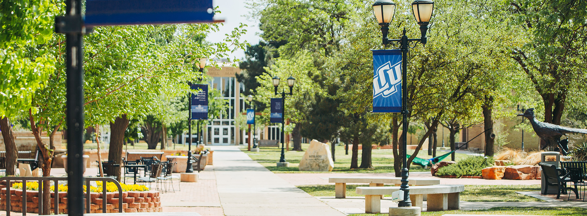 photograph of LCU's Mall area in the spring with blue LCU banners