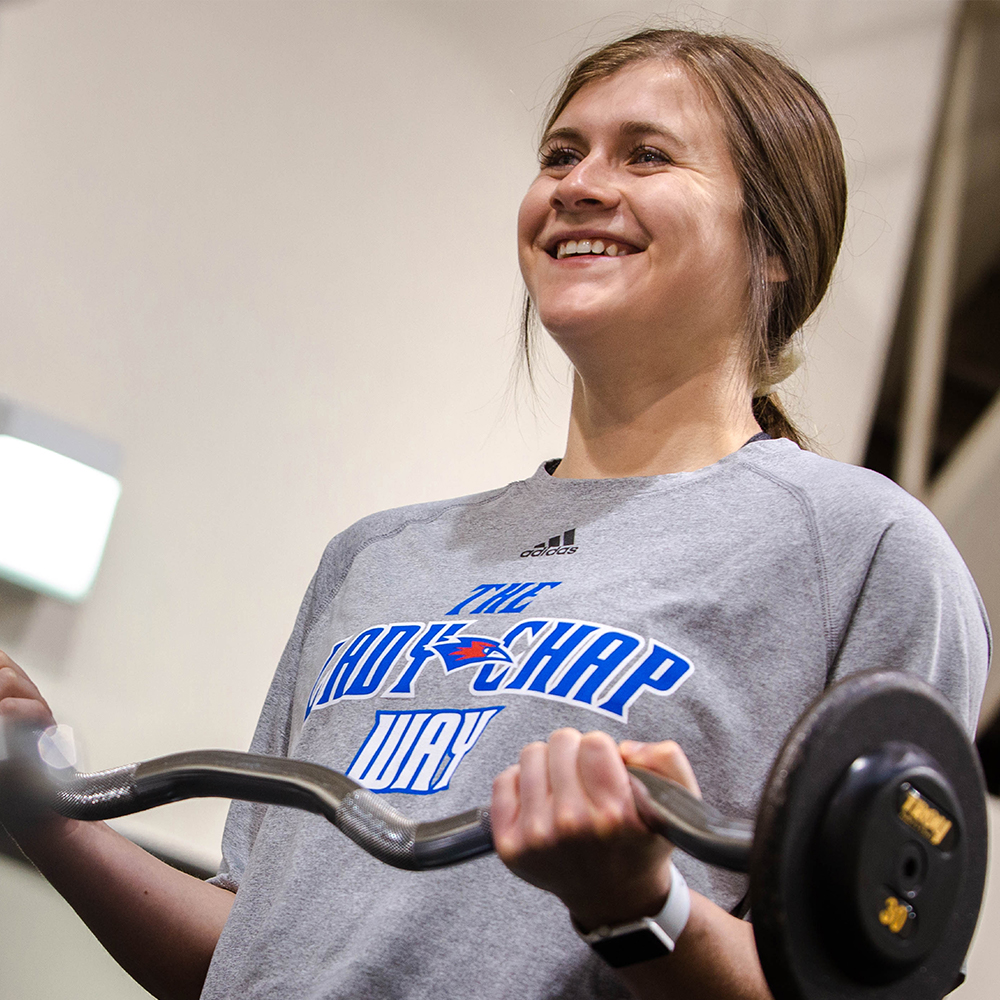 girl holding a barbell