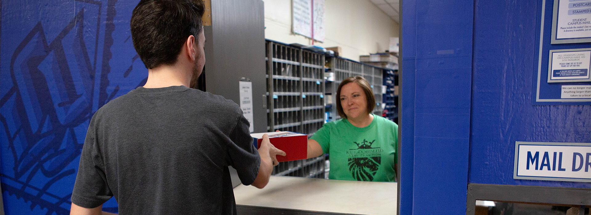 Student picking up package at post office