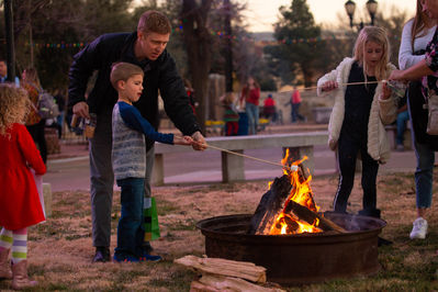 Family roasting marshmallows at Big Blue Christmas