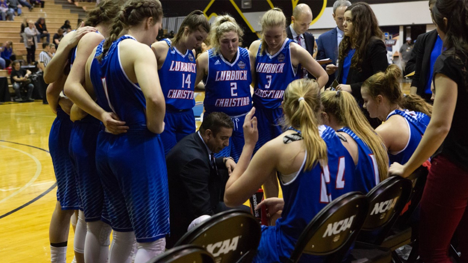Lady Chaps surround Coach Gomez to hear the game plan