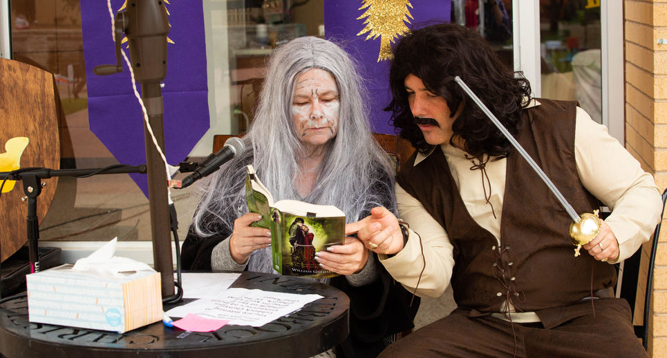 Dr. Carole Carroll and Dean of Students, Josh Stephens, in costume reading "The Princess Bride" 
